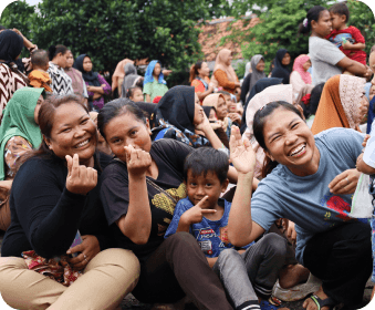 Women from the local community smiling together